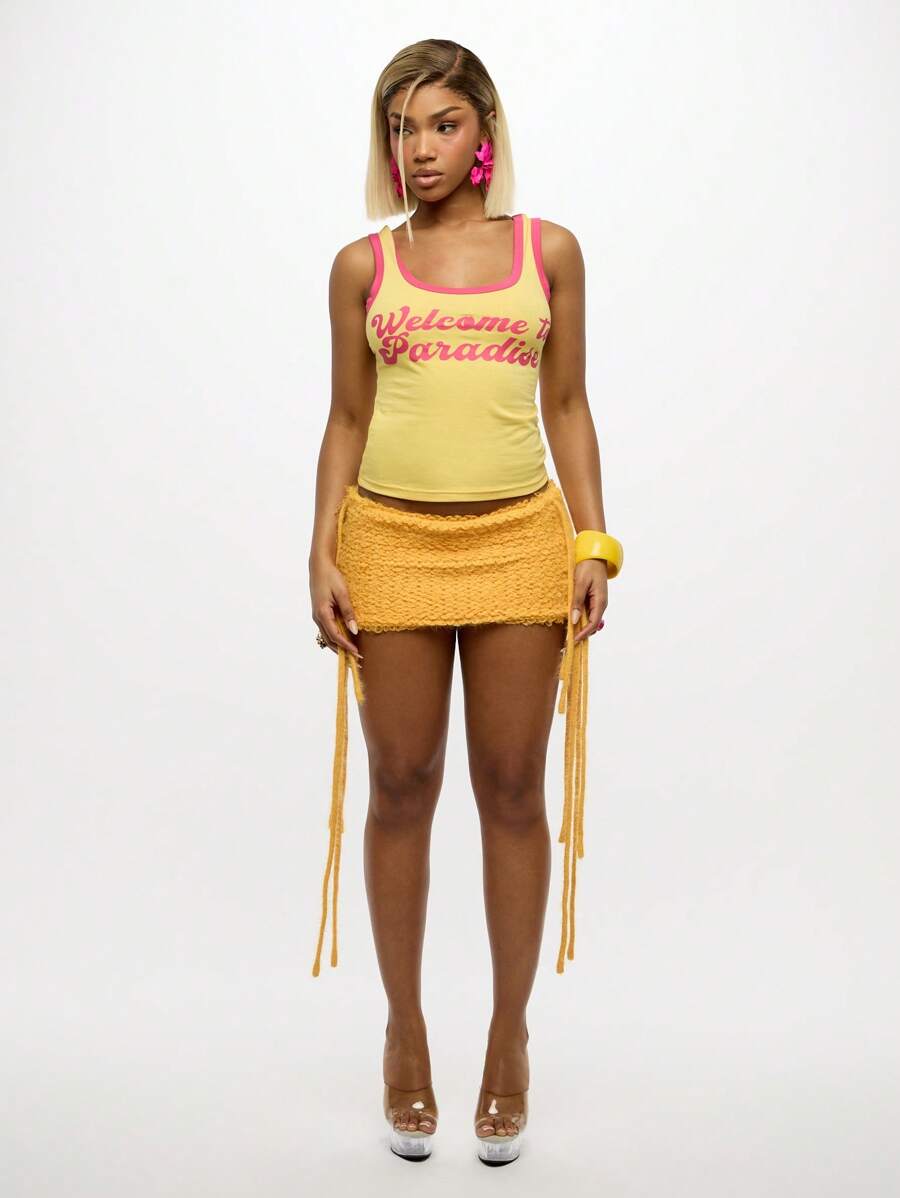 Sixtylia – Jupe mini en tricot à franges et liens latéraux