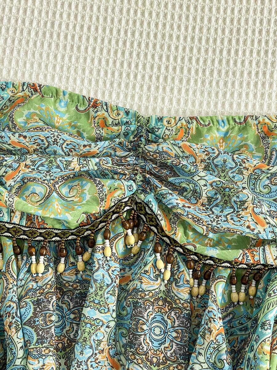 Flirla – Blouse en chiffon à lien taille unique et ourlet asymétrique